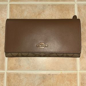 Brand new.  Never used. Coach wallet.   14 card holder.